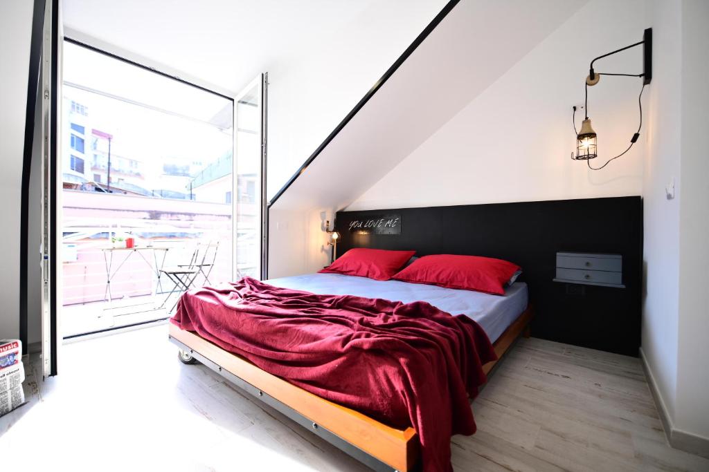 a bedroom with a large bed with red pillows at Le Comprese - B&b Experience in Battipaglia