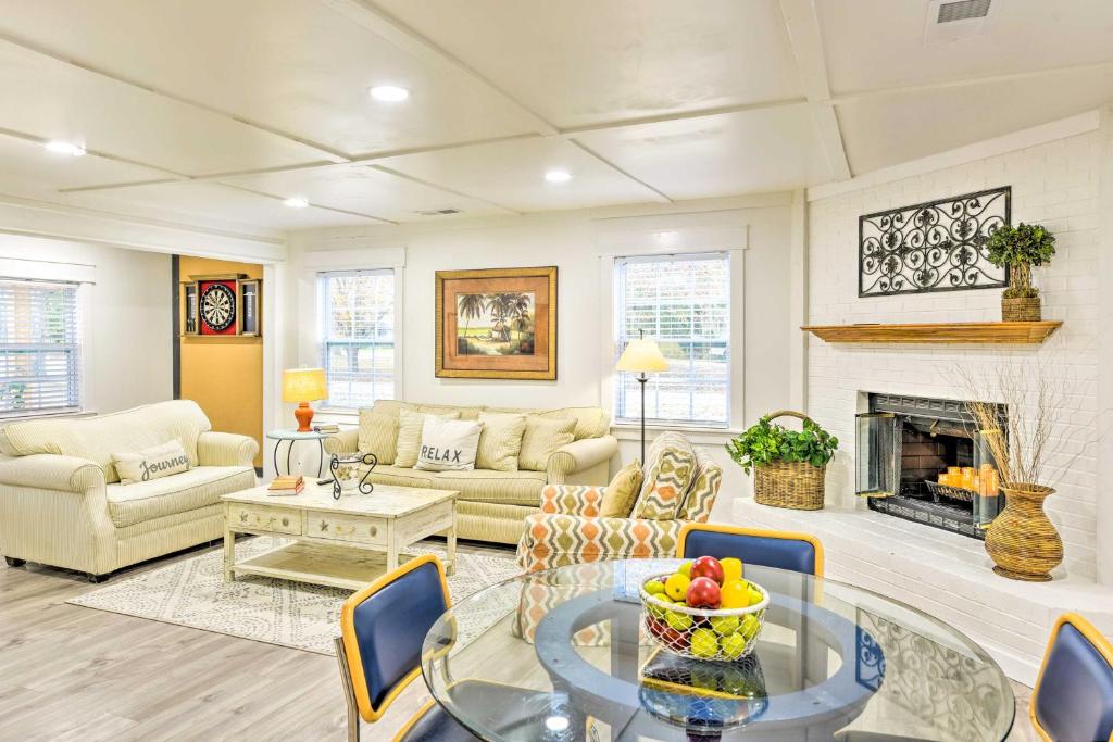 a living room filled with furniture and a fireplace at Bright Beaufort Home with Porch and Fire Pit! in Beaufort