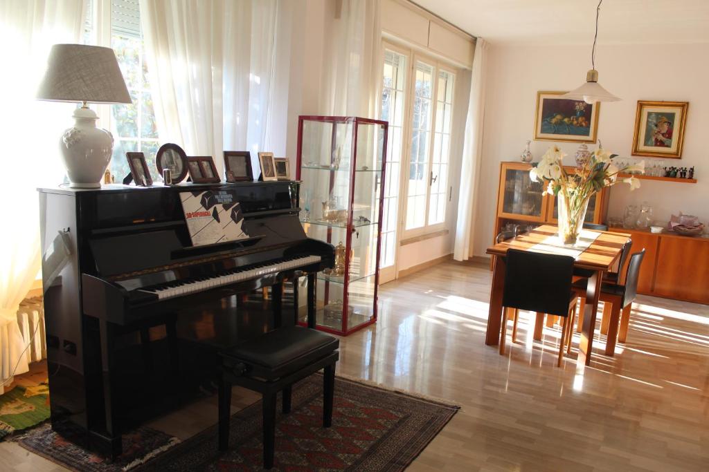 a living room with a piano and a table at Baki B&B in Rimini