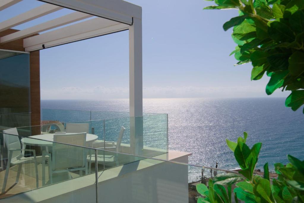 a view of the ocean from the balcony of a house at BEST CALACEITE SUNSET VIEWS in Torrox Costa