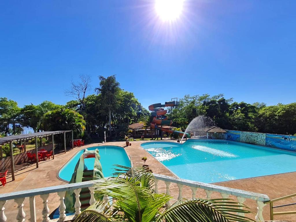 a pool at a resort with a slide at Pouso da Garça Pousada Resort in Teodoro Sampaio