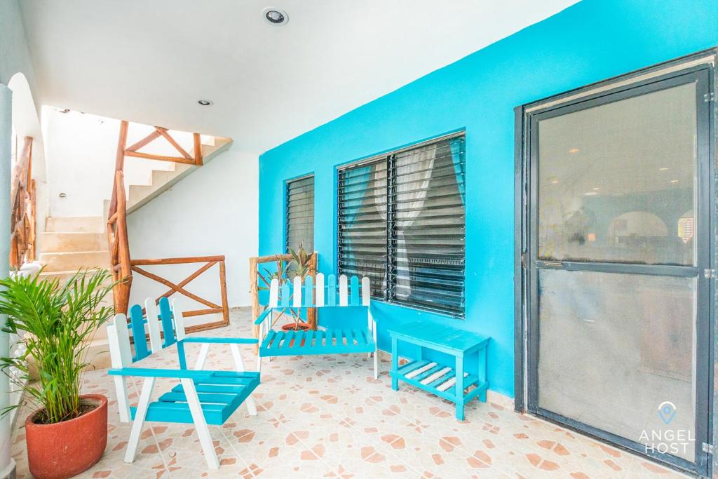 a room with two chairs and a blue wall at Malecon Beach House in Progreso 1 block from beach in Progreso