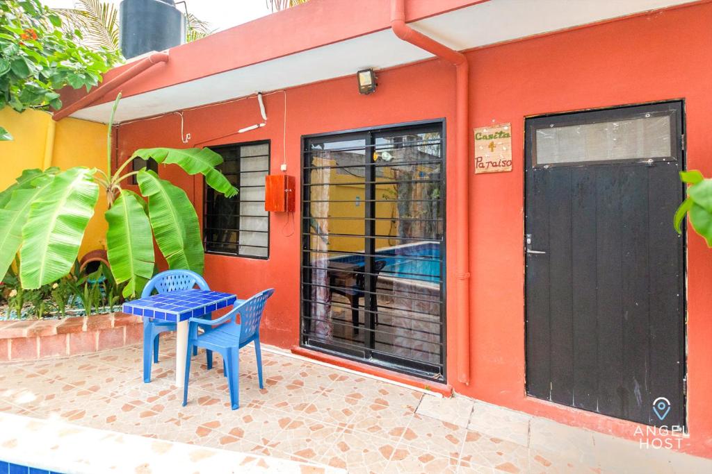 a table and chairs in front of a house at Malecon Beach House in Progreso 1 block from beach in Progreso