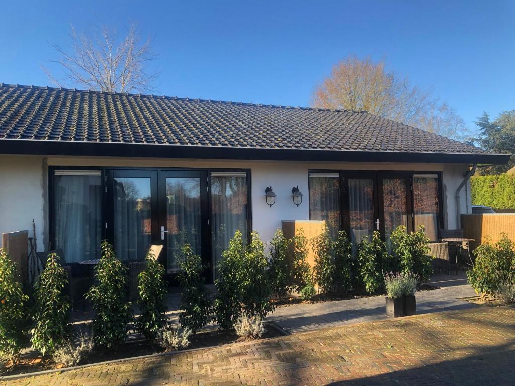 a house with plants in front of it at B&B 't Speulderbos in Ermelo