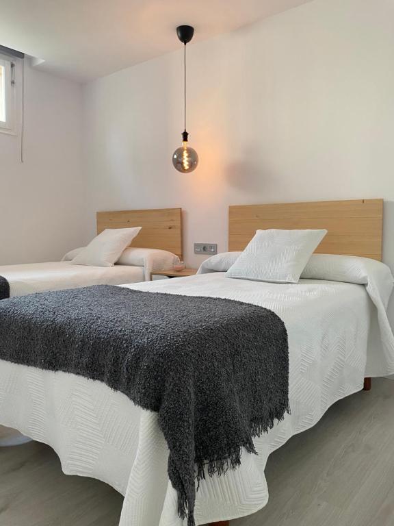 Postel nebo postele na pokoji v ubytování Apartamentos el Oligo