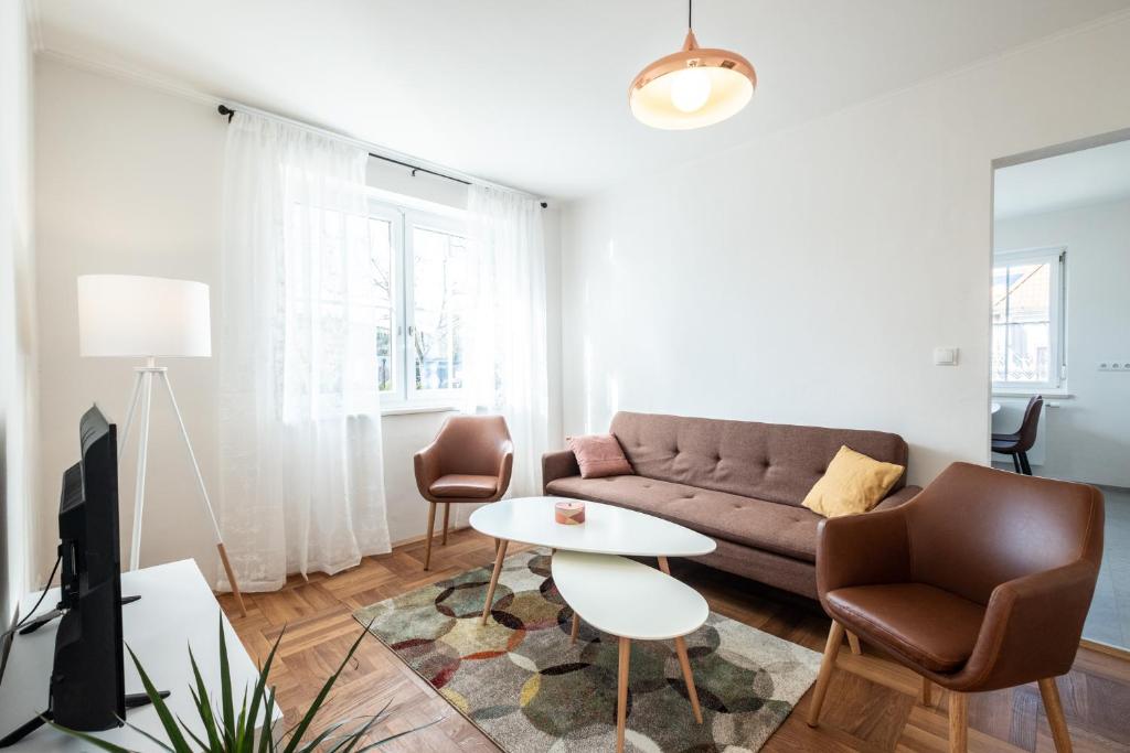- un salon avec un canapé et une table dans l'établissement OMA's Apartment in Haus GRETE, à Bad Waltersdorf
