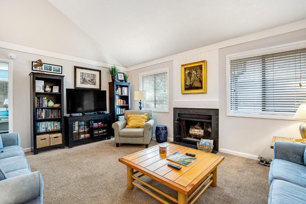 a living room with a coffee table and a fireplace at Oceanwoods 452 in Kiawah Island