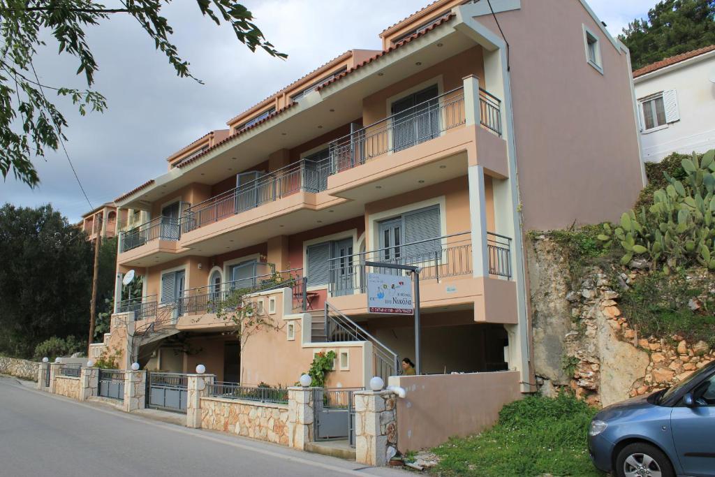 een gebouw met balkons aan de straatkant bij The Seasons of Nickolas in Ayia Evfimia