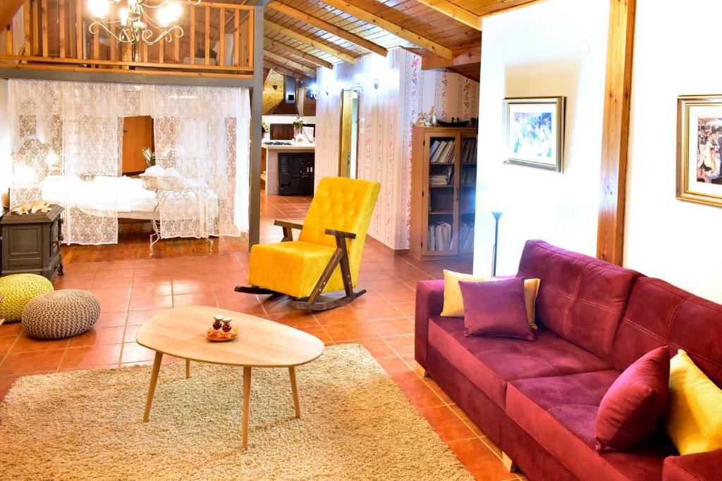 sala de estar con sofá púrpura y silla amarilla en אוויר הרים, en Kefar Weradim