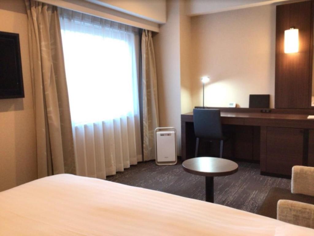 Postel nebo postele na pokoji v ubytování Matsue Excel Hotel Tokyu