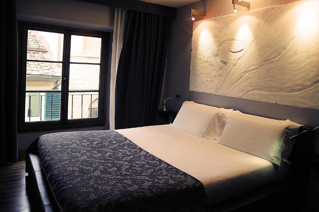 En eller flere senger på et rom på Borghese Palace Art Hotel