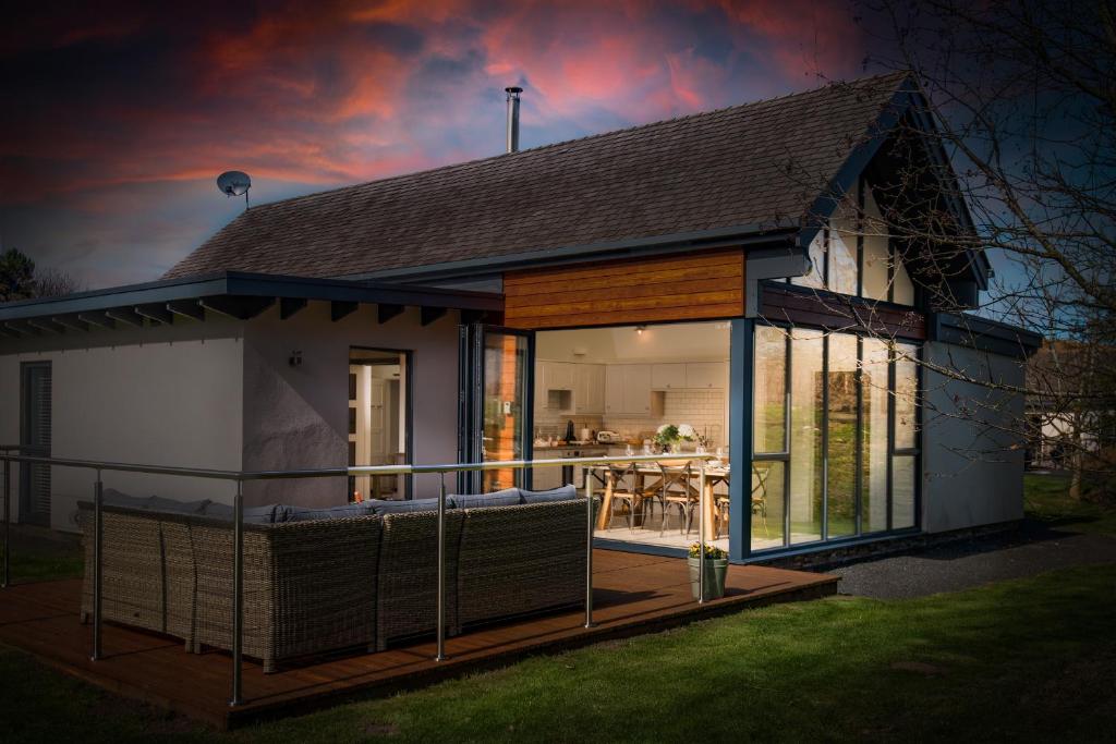 a small house with a large deck in front of it at Lambs Lodge in Bamburgh