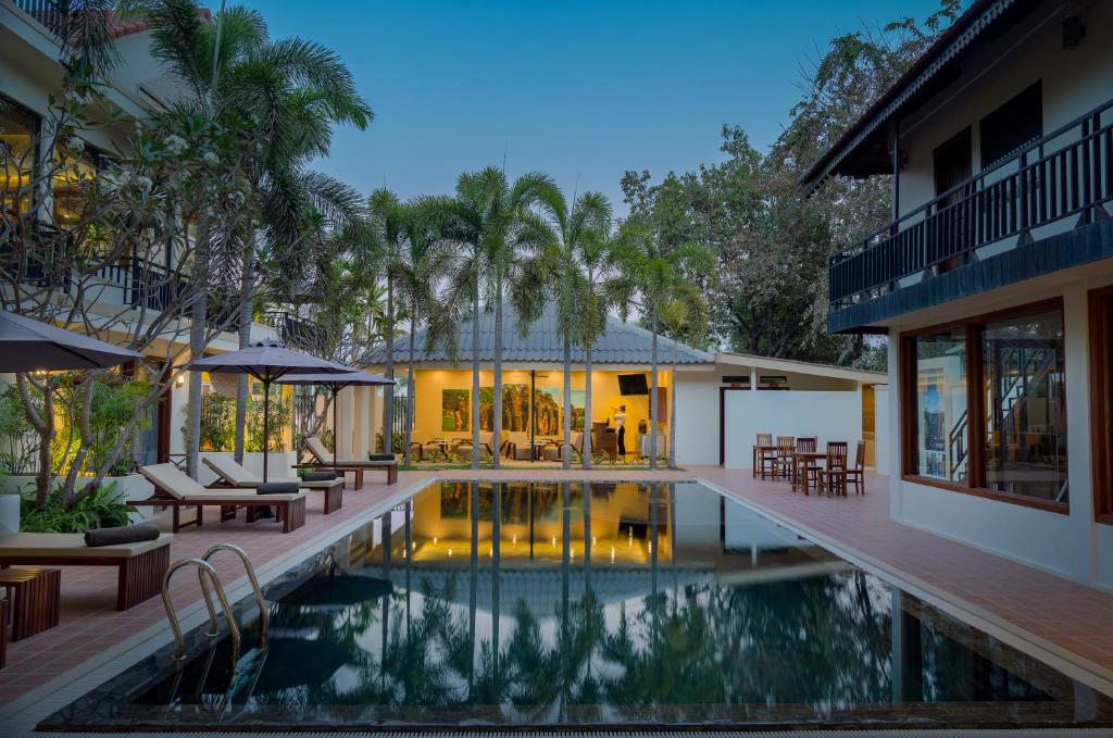 an external view of a house with a swimming pool at Amatak Boutique Hotel in Siem Reap