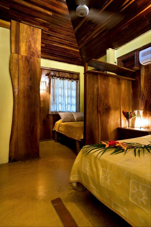 Postel nebo postele na pokoji v ubytování Hotel Tropico Latino