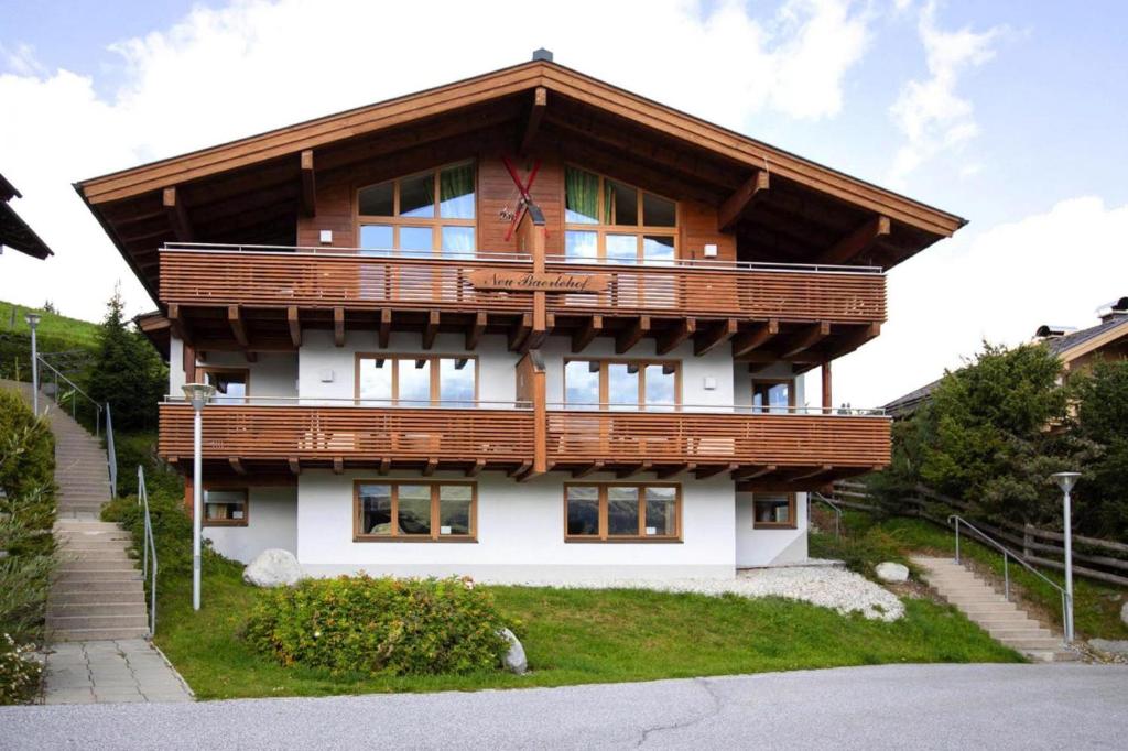 a large house with a wooden roof at Holiday flats B rlerhof K nigsleiten in Königsleiten