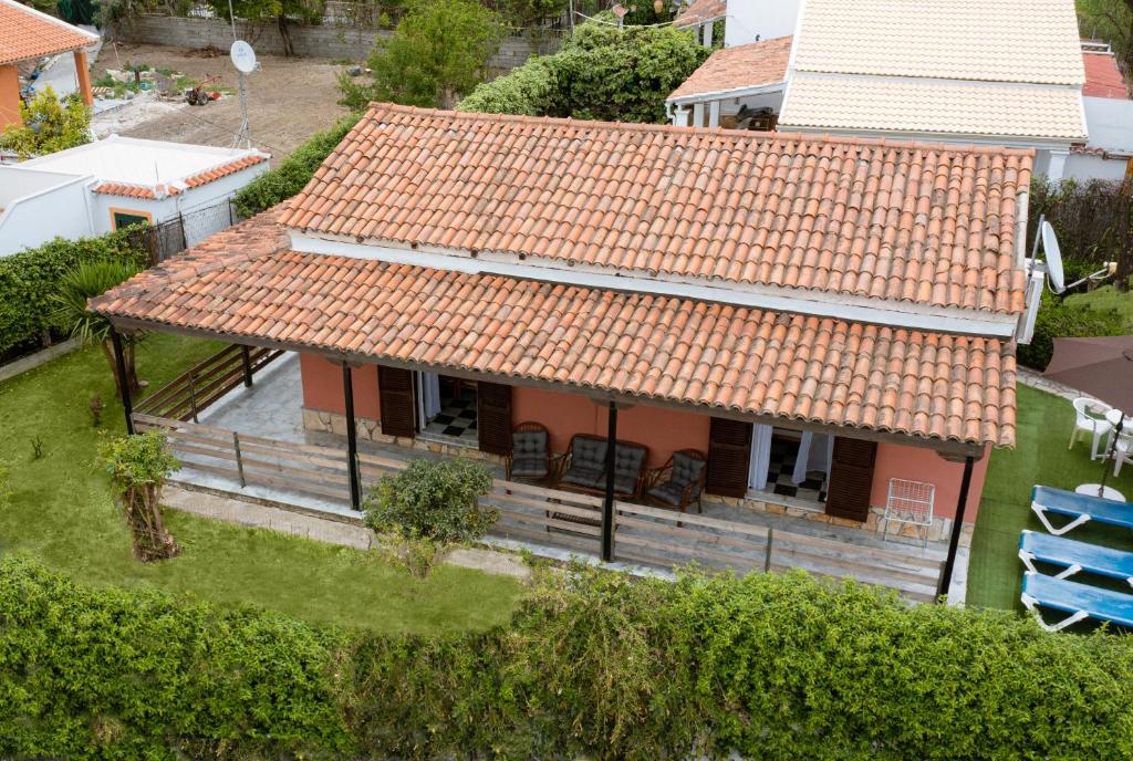 an overhead view of a house with an orange roof at Villa Popi on the beach of Agios Gordios in Agios Gordios