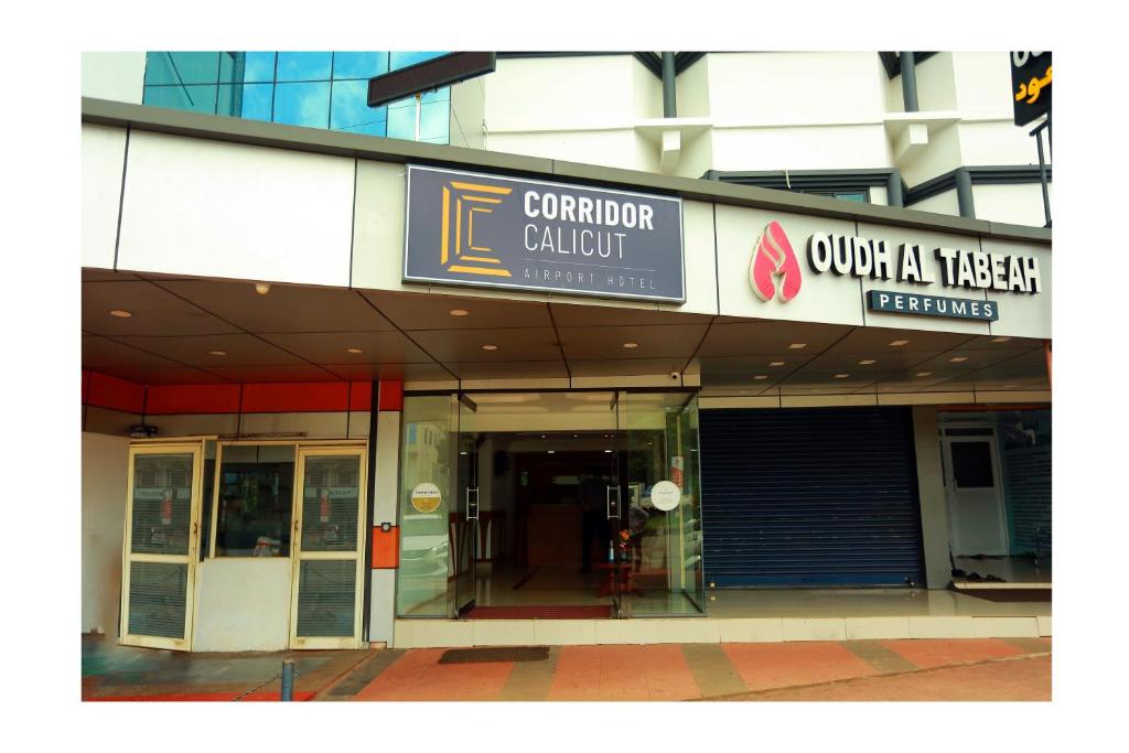 an entrance to a building with a sign on it at CORRIDOR CALICUT Airport Hotel in Kondotti