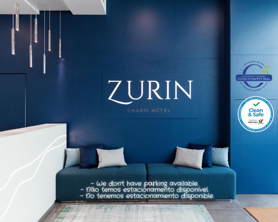 a blue wall with a blue couch in a room at Zurin Charm Hotel in Lisbon