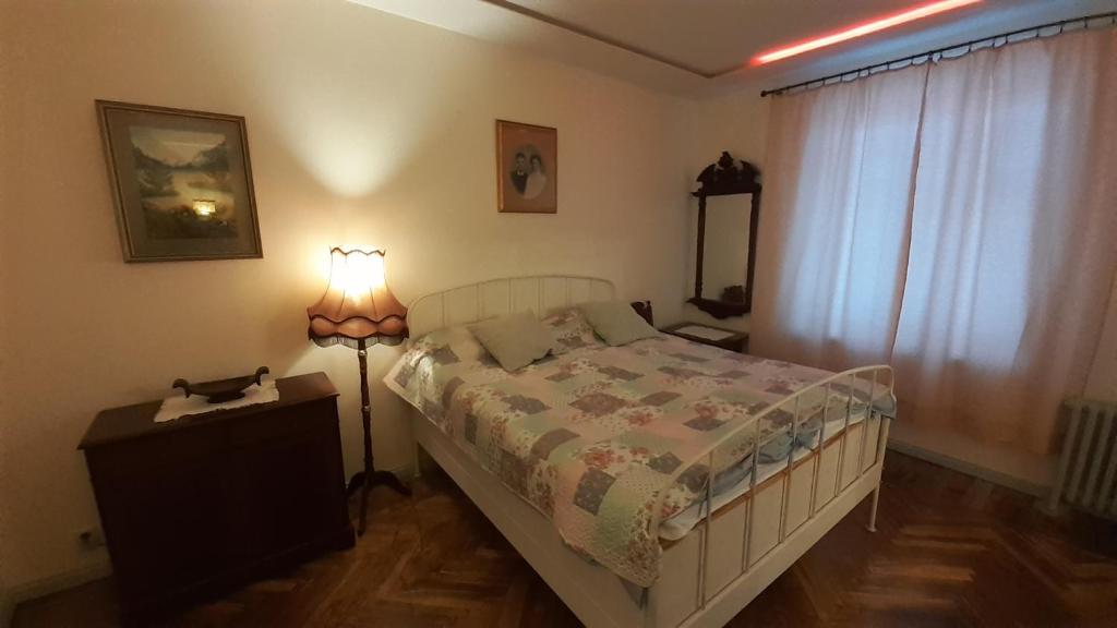 a bedroom with a bed and a lamp in it at Majakovski Junior Suite in Sillamäe