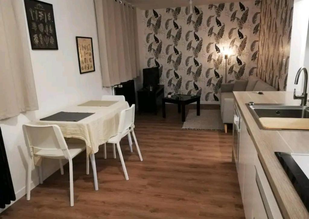 a kitchen and dining room with a table and chairs at Joli T2 près de Rennes in Vezin-le-Coquet