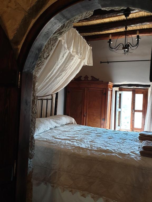 a bedroom with a large bed with a canopy at Vasilopoulos House in Tochni