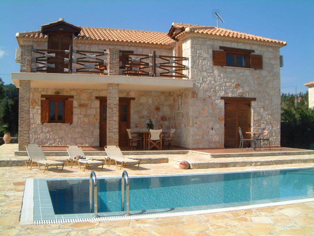a house with a swimming pool in front of it at Villa Karissa - Zante in Vasilikos