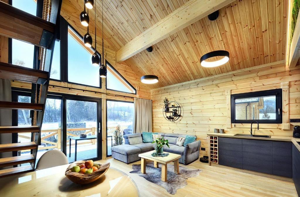 a living room with a couch and a table at Vila Valentina Luxury Chalet in High Tatras in Veľká Lomnica