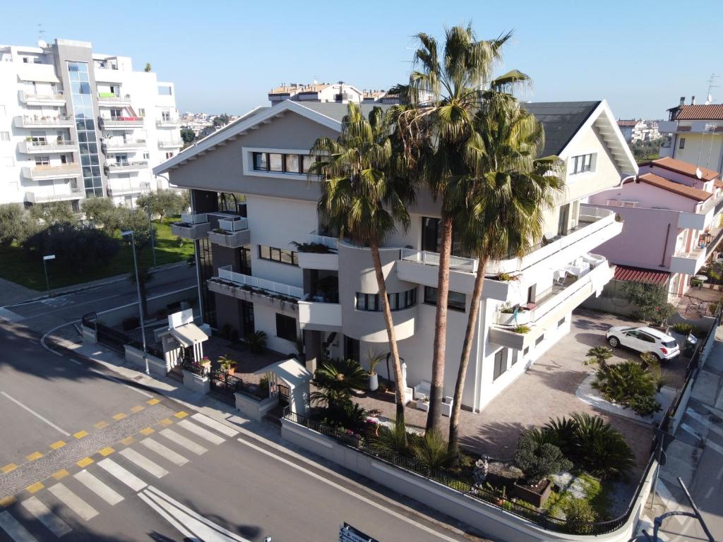 an aerial view of a building with palm trees at B&B La Suite Alba Adriatica in Alba Adriatica