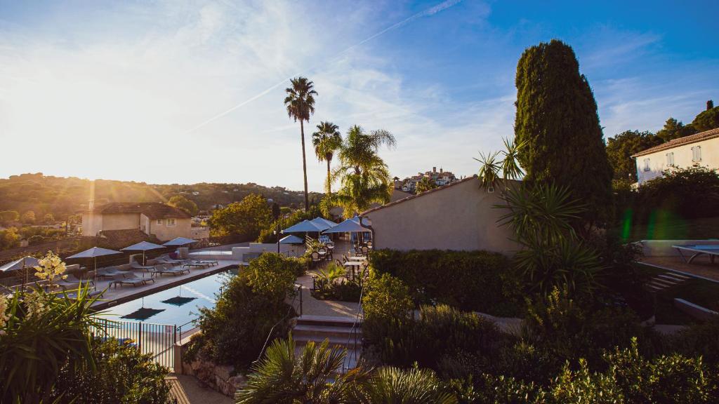 an overhead view of a resort with a pool and palm trees at La Bastide de Biot in Biot