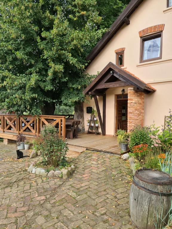 a porch of a house with a wooden deck at Swojski Gościniec in Prażmowo