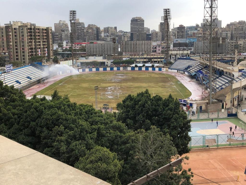 a large park with a fountain in a city at Three-Bedroom Apartment in Mohandseen in Cairo