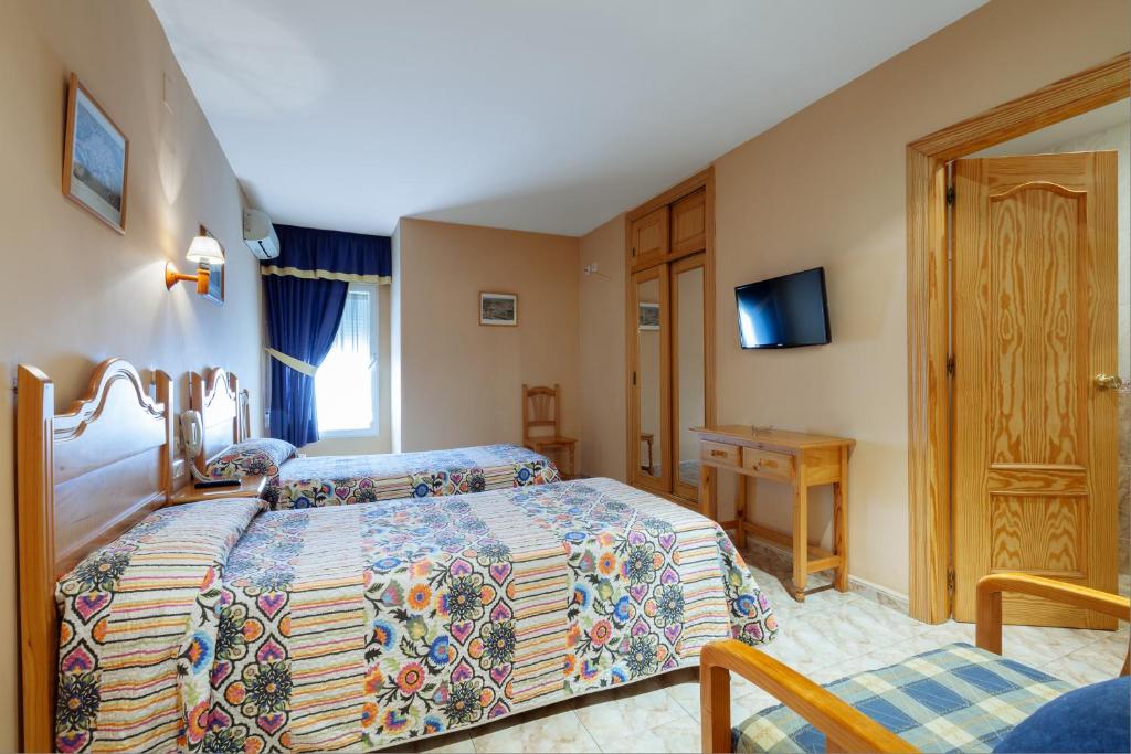 Postel nebo postele na pokoji v ubytování Hotel Philadelfia