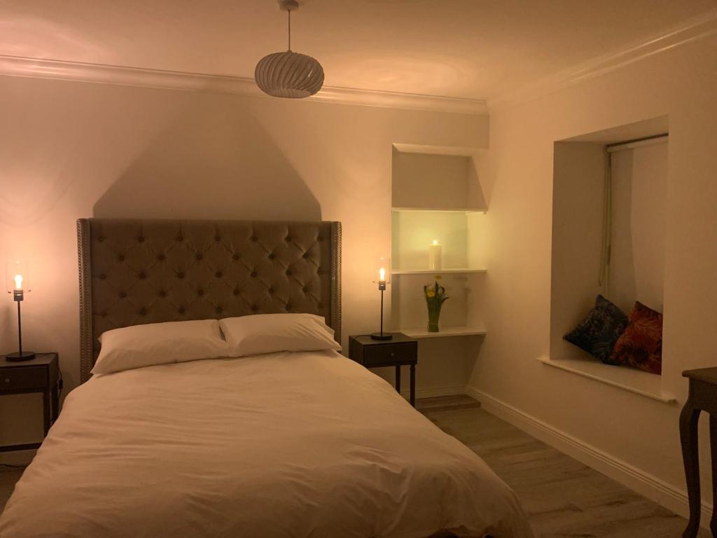 a bedroom with a large white bed with two night stands at Alta House in Westport