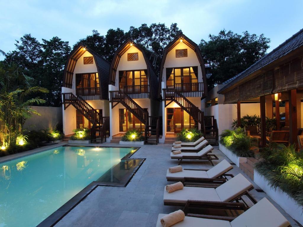 an image of a house with a swimming pool at Mojo Resort Canggu in Canggu