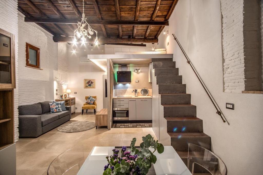 a living room with a staircase and a couch at Casa Vantaggio in Rome