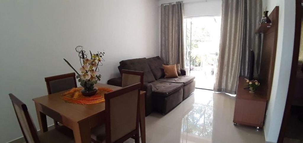 a living room with a couch and a table with a tableablish at Sua casa em Foz do Iguaçu. Apt encantador e aconchegante na Vila A. in Foz do Iguaçu