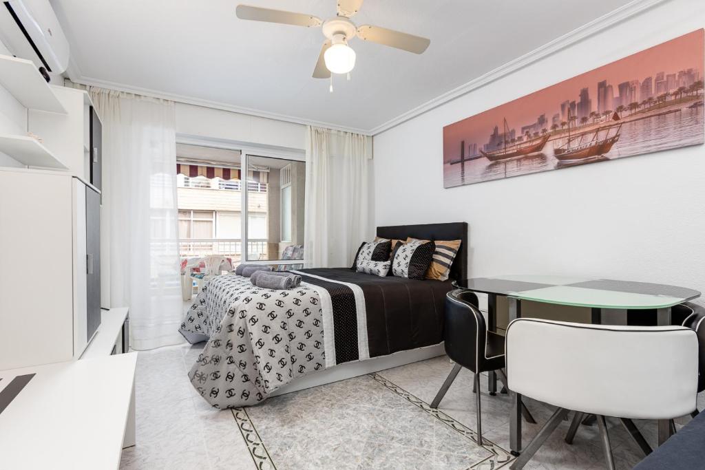 a bedroom with a bed and a table at Studio Playa del Cura in Torrevieja