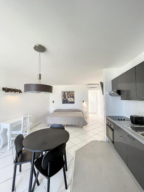 a kitchen and living room with a table and chairs at Le Domaine Anse Marcel Beach Resort in Anse Marcel 