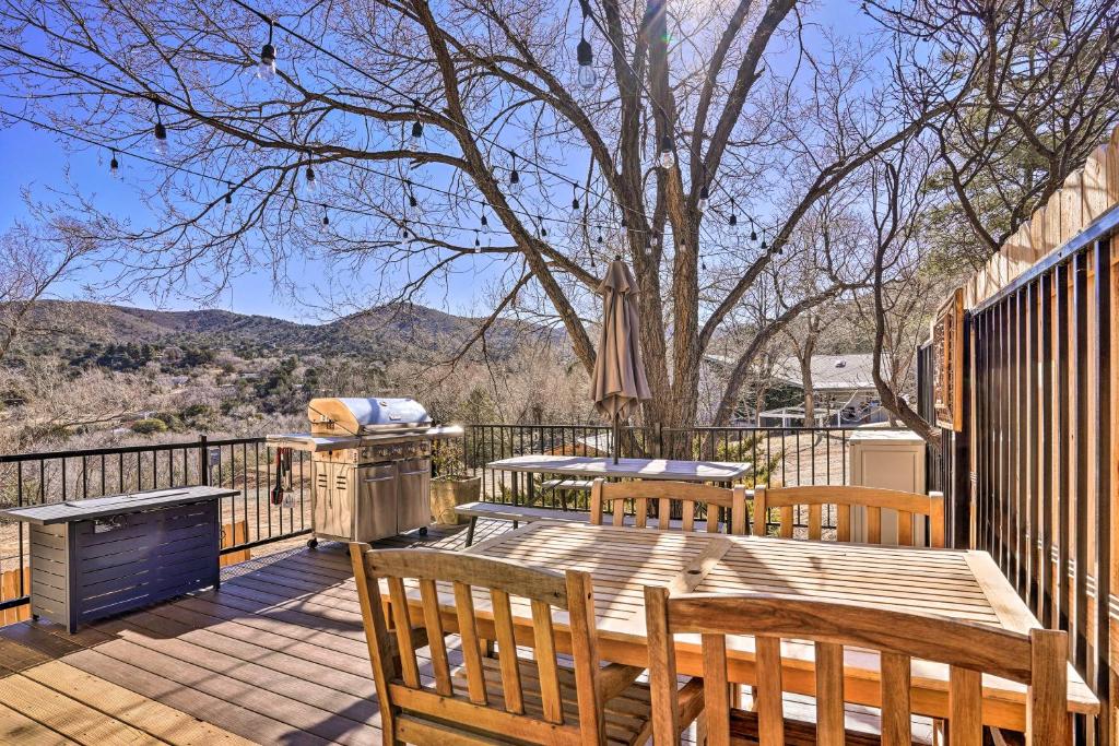 a deck with a table and chairs and a grill at Prescott Home with Deck and Grill Close to Hiking! in Prescott