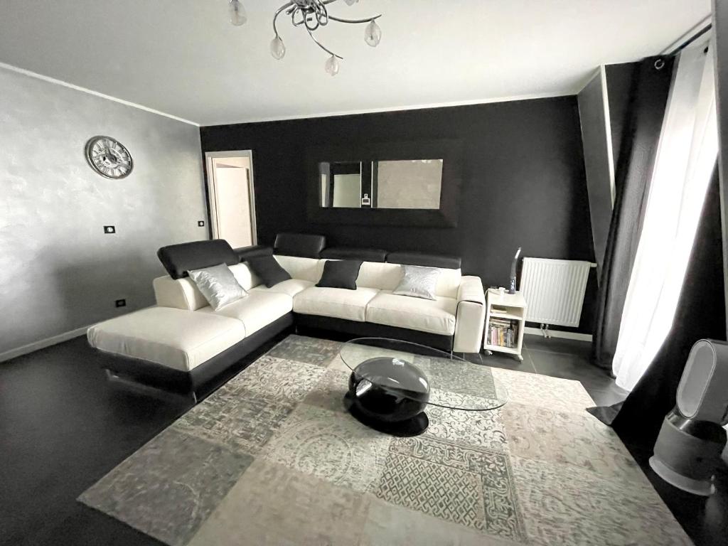 a living room with a couch and a table at Appartement near Disney Parks in Chessy