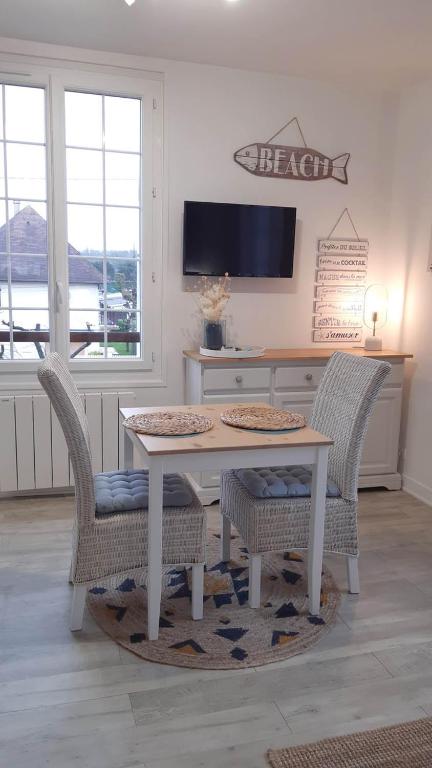 une salle à manger avec une table et deux chaises dans l'établissement Studio proche du centre ville et de la plage, à Villers-sur-Mer