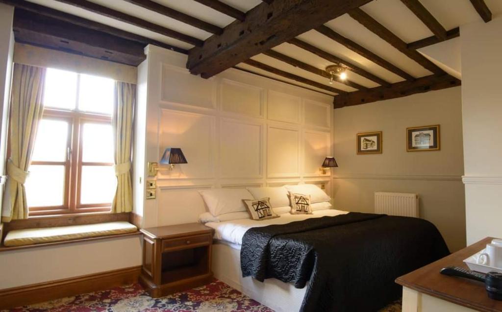 a bedroom with a bed and a window at The Grange at Mortimers Cross 