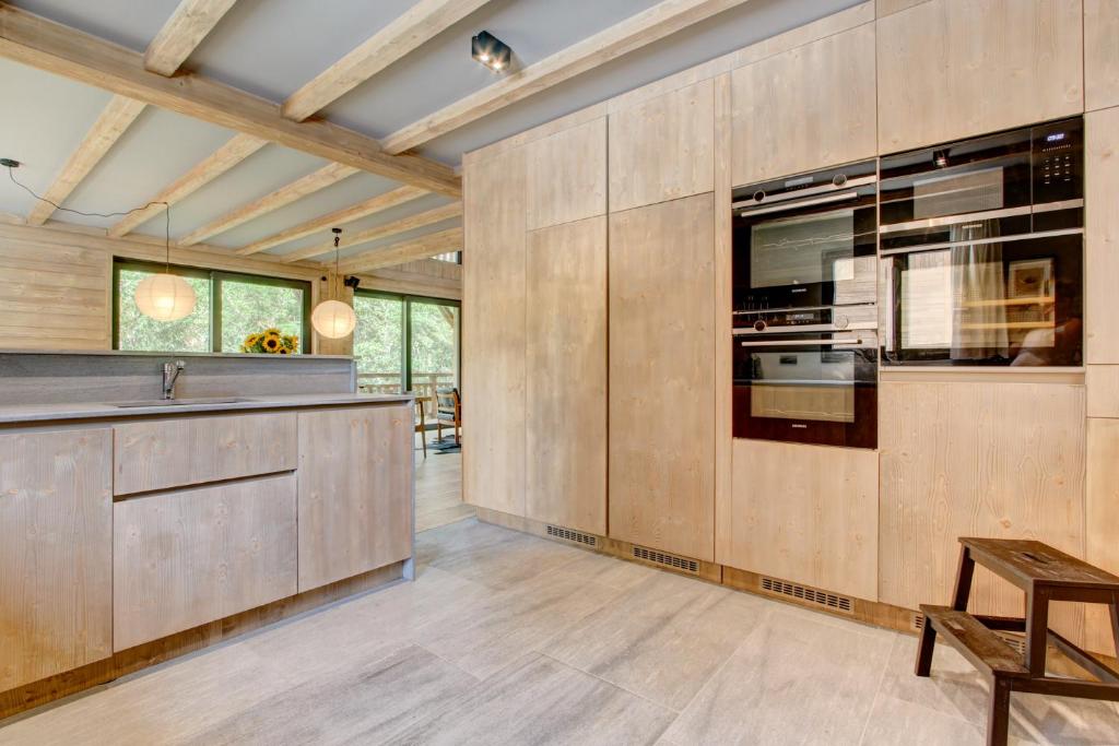 a kitchen with wooden cabinets and a counter top at Chalet La Mésange Boréale in Morzine
