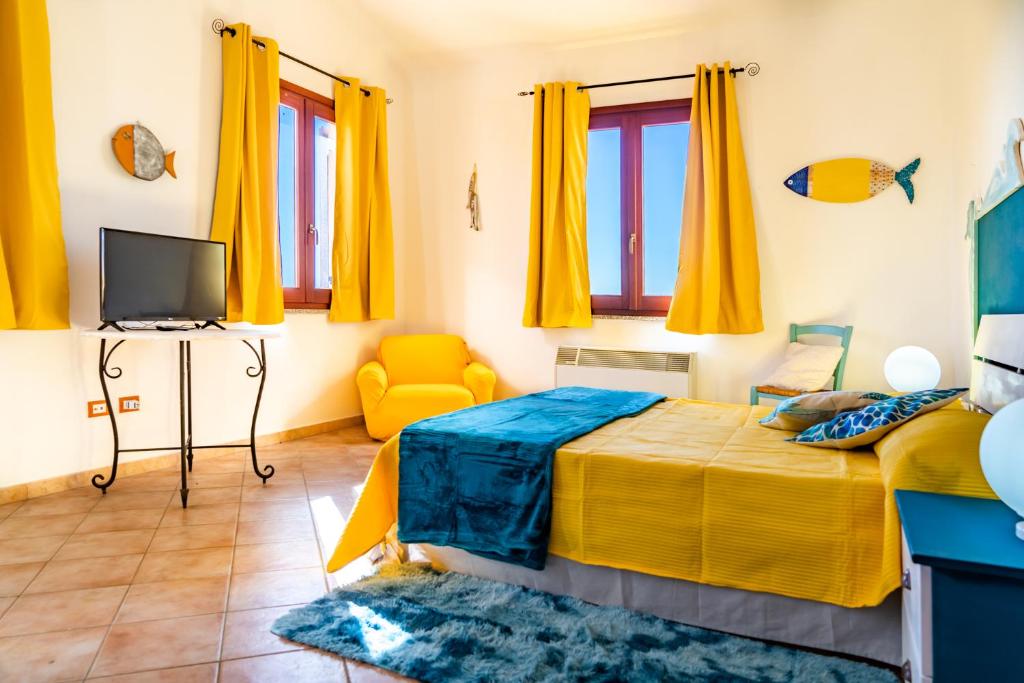 a bedroom with a television and a bed at Nora Guesthouse Rooms and Villas in Pula