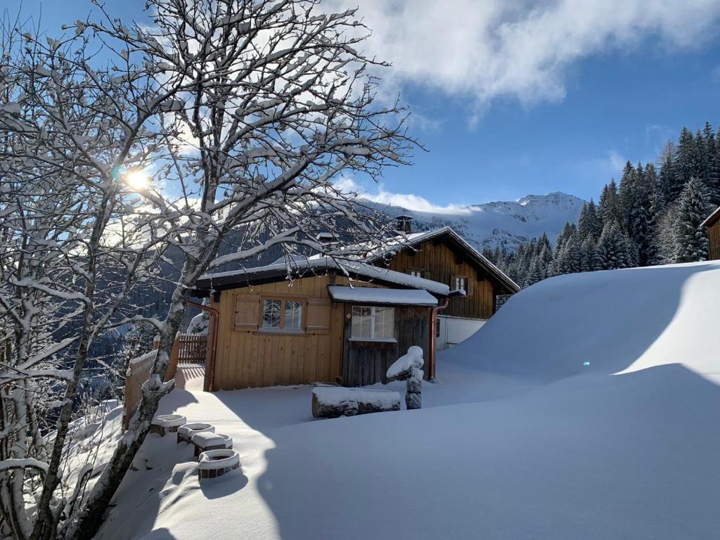 a cabin with snow on the ground next to it at Nüggili's Maisäß in Tschagguns
