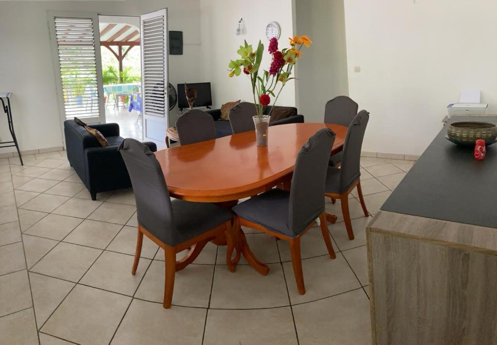 a dining room with a wooden table and chairs at Haut de Villa chez Ghighi in Abondance