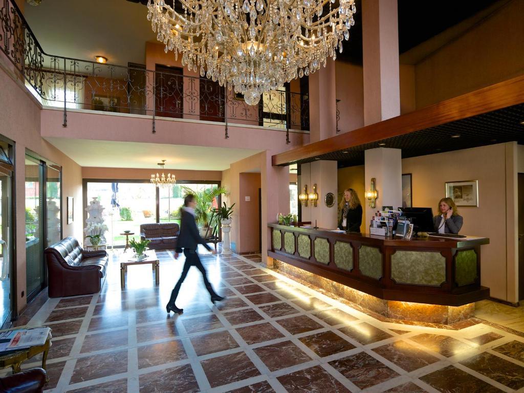 a person walking through a lobby of a hotel at Hotel Garni Geisler in Cologne