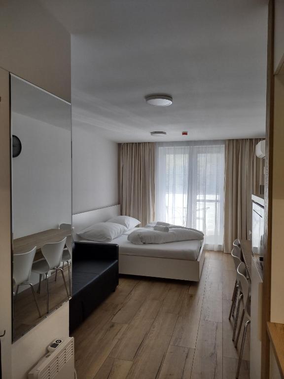 Postel nebo postele na pokoji v ubytování Apartmany Arcadia