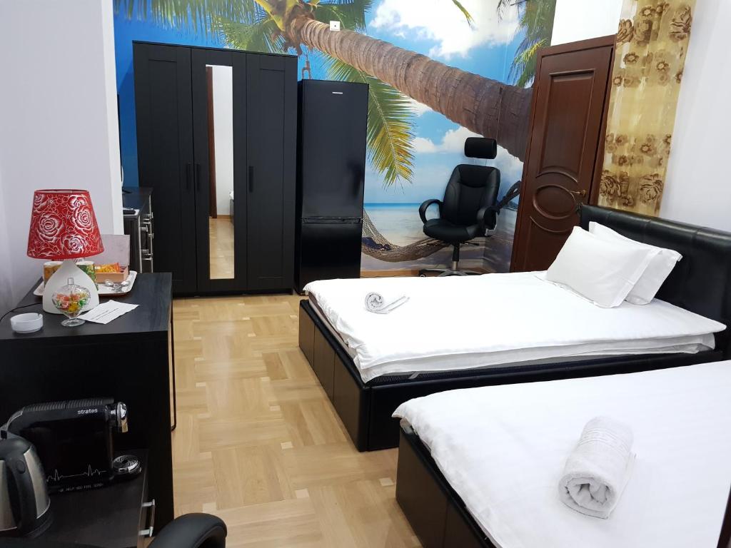 a bedroom with two beds and a table with a camera at Monza National Arena Mega Mall Ap in Bucharest