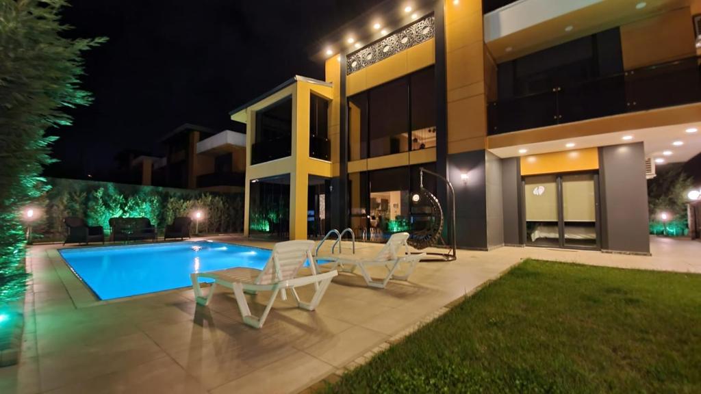 a house with a swimming pool at night at Villa Aysha 2 in Sapanca